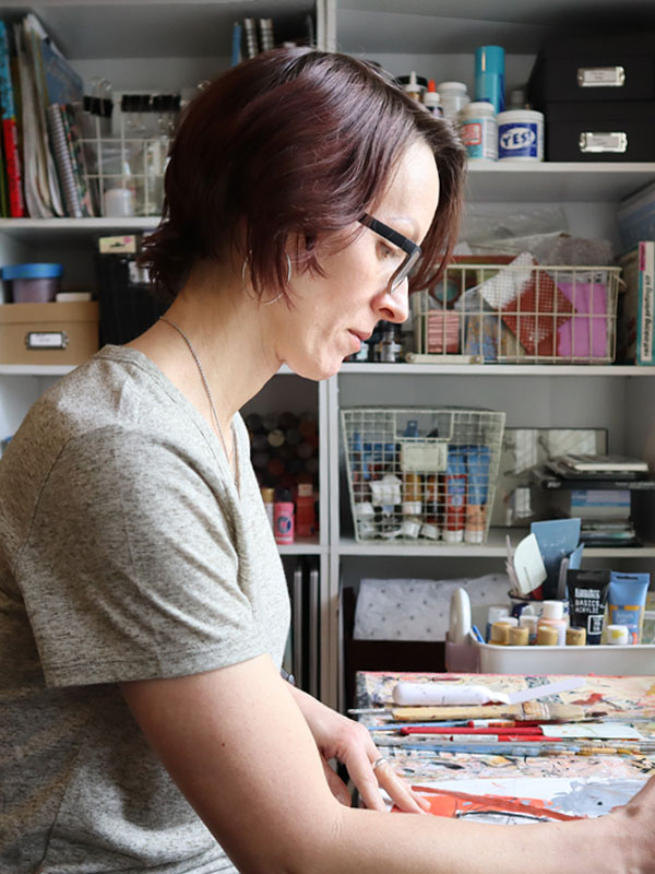 Jennifer Rios in her studio working on a painting
