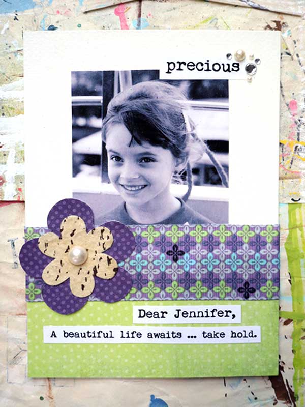 Art card with picture of a young girl, patterned paper and flower embellishments, and an inspirational saying