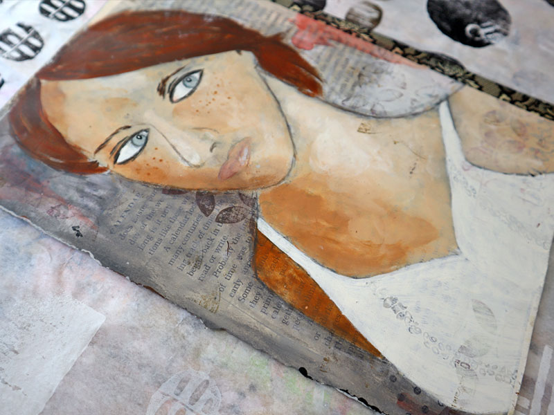 Painting of a girl with blue eyes and short red hair on a background of book pages washed with gray paint