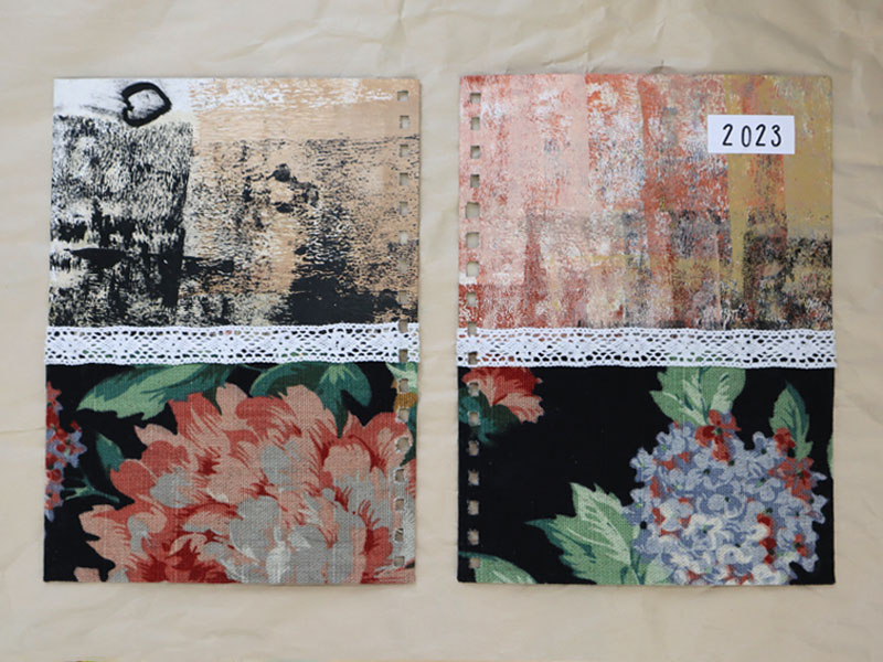 Custom planner cover with floral fabric, hand painted paper, and crochet trim