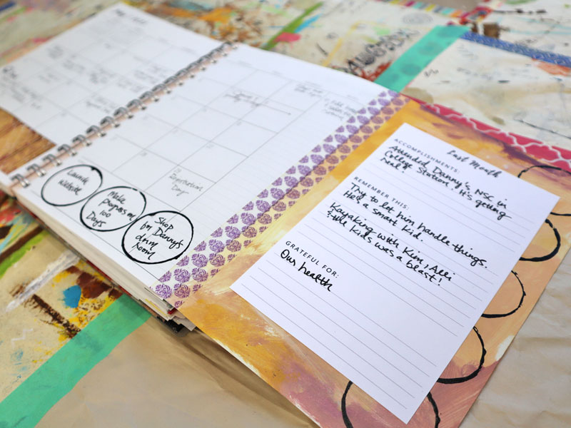 new fill in the blank monthly recap page added to planner with washi tape shown laying open