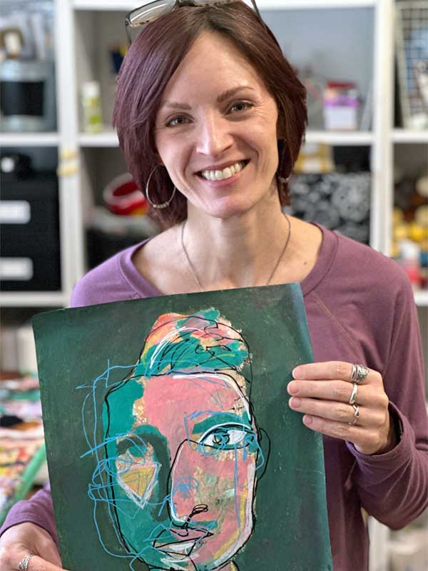 Artist Jennifer Rios from 1010artistry holding a painting of an abstract face that combines tones of pink, green, and yellow with multiple line drawings of the face
